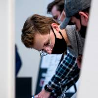 Student reading presentation notes